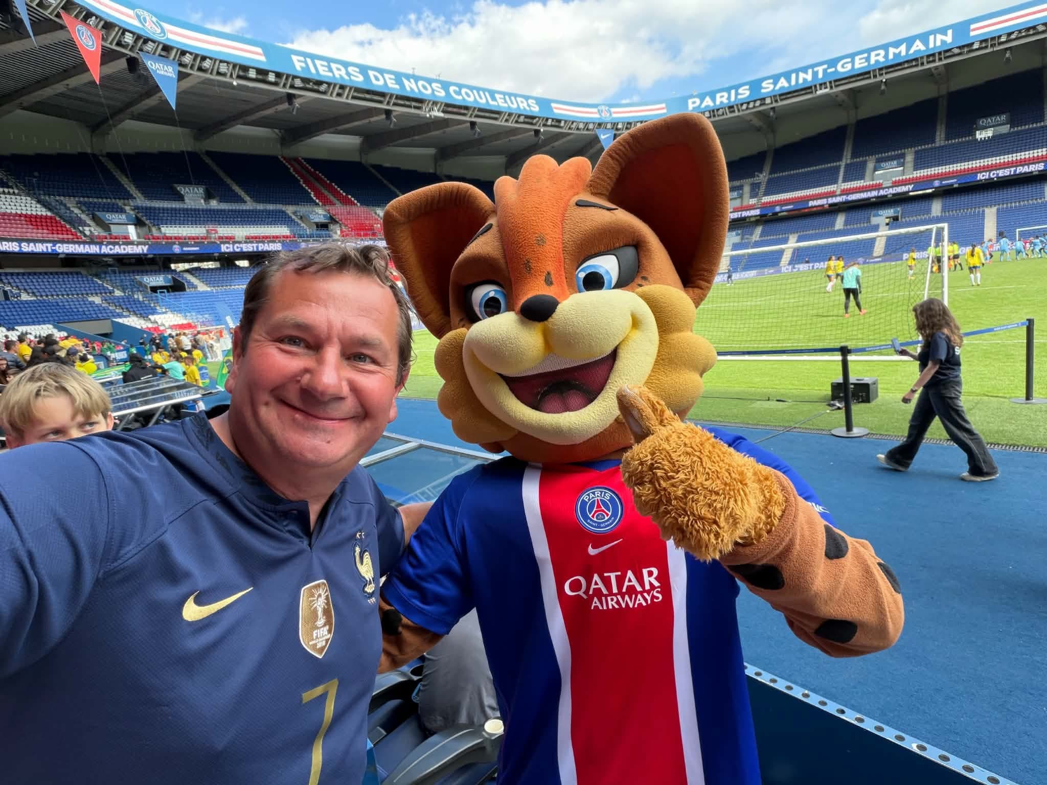 Marc Asmode at the Parc des Princes in Paris, with the Paris Saint-Germain mascot.